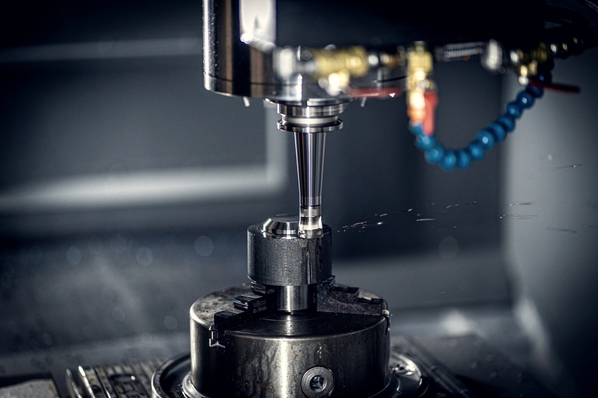 Milling spindle with coolant lines over a workpiece