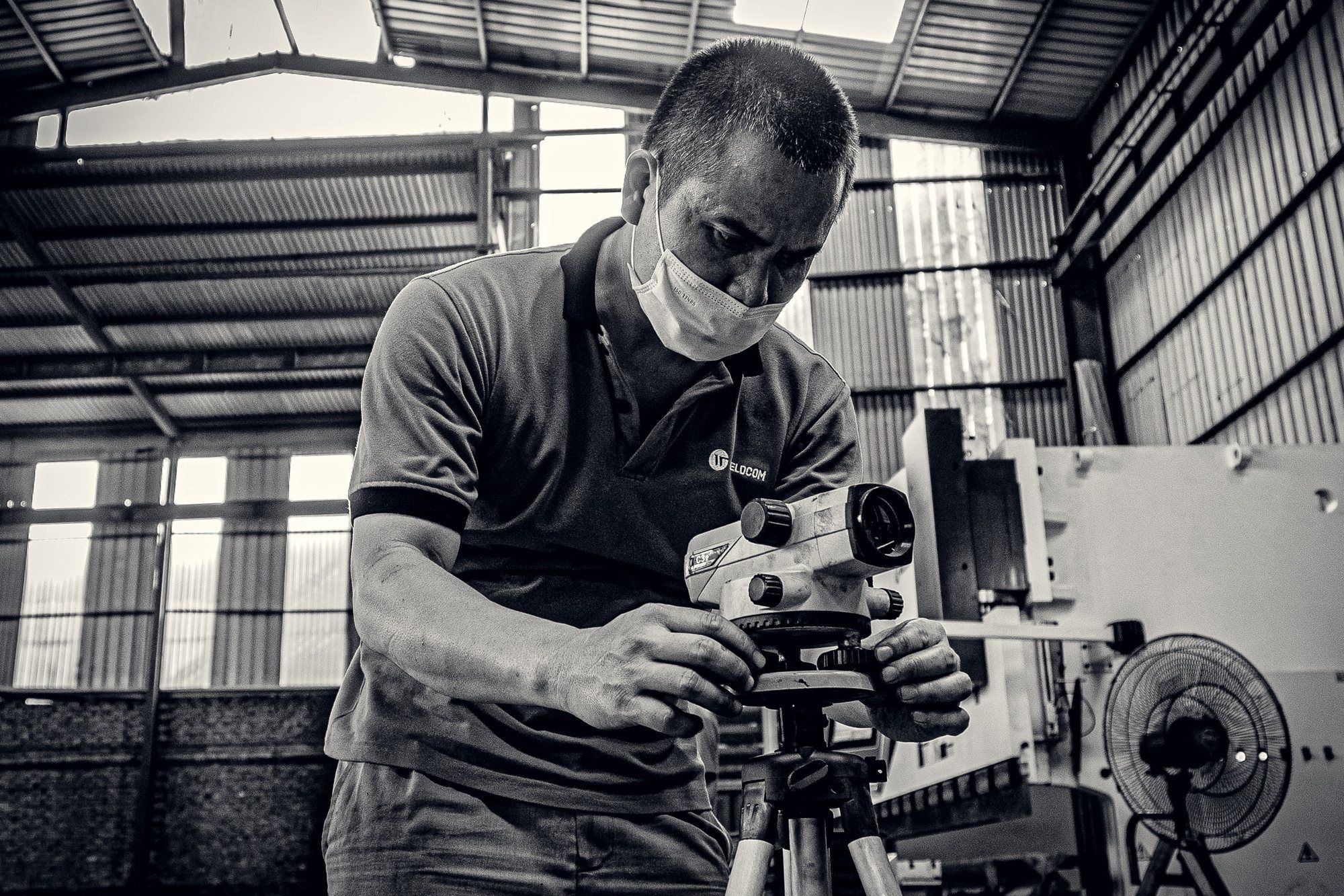 Technician setting up a measuring instrument on the shop floor